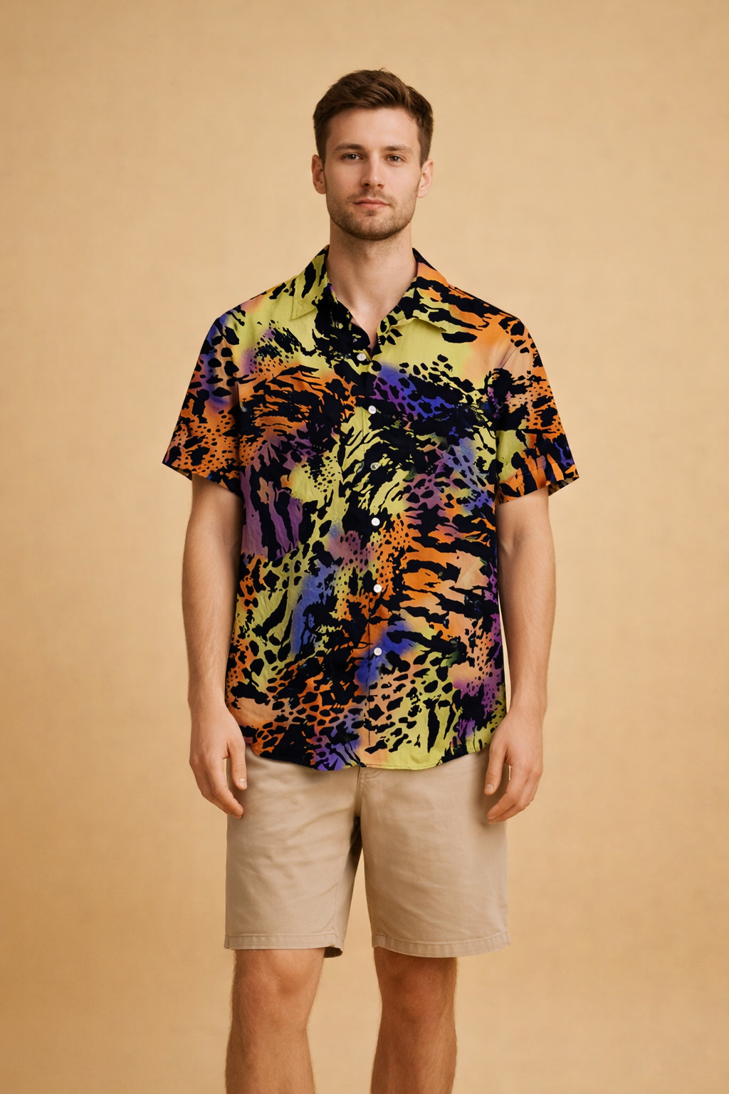 Short-sleeve button-up shirt with a bold abstract animal-inspired pattern in layered dark and vibrant tones, styled with tailored knee-length shorts featuring a clean straight fit and smooth finish.
