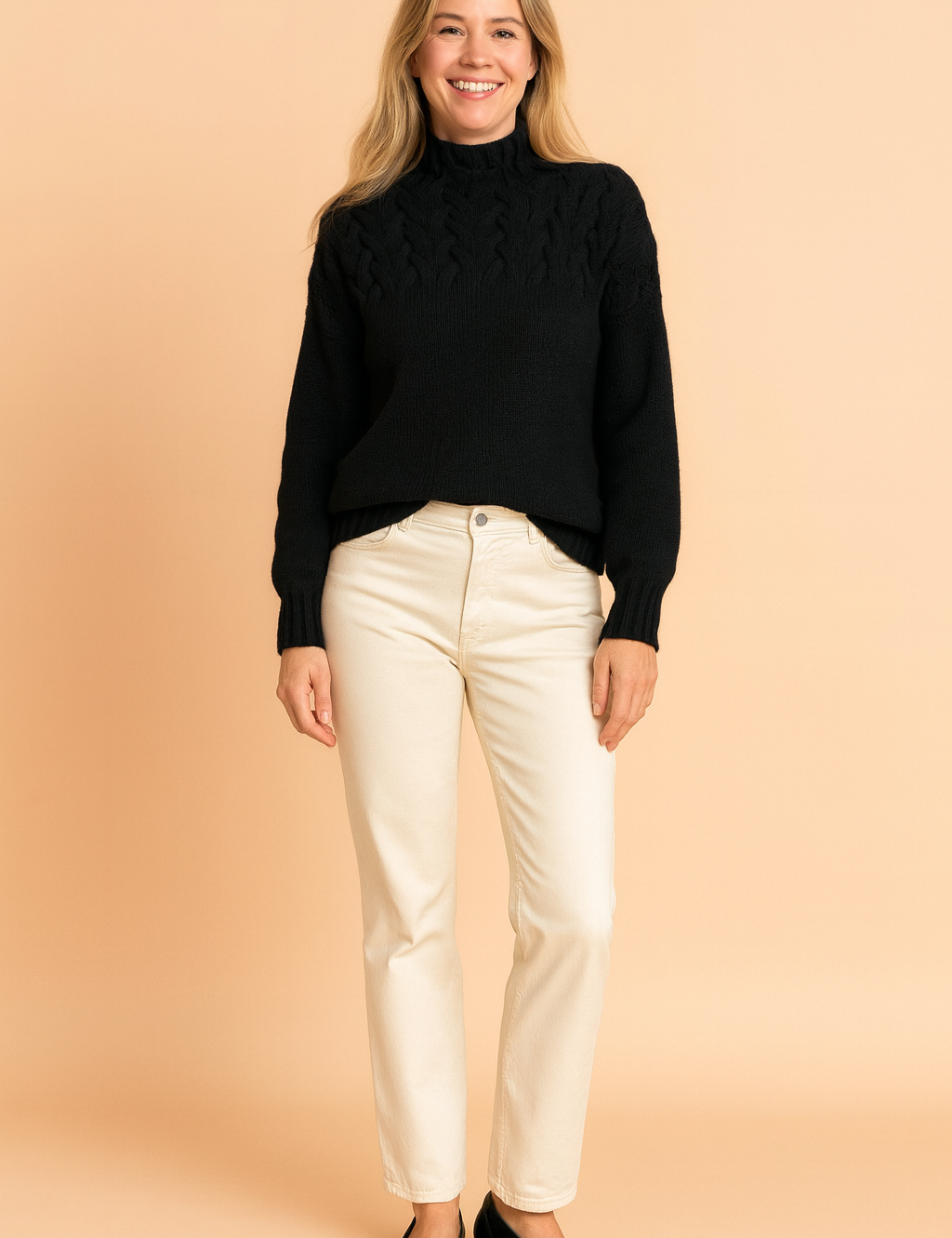 Black cable-knit high-neck sweater paired with cream straight-leg jeans and black low-heeled shoes.