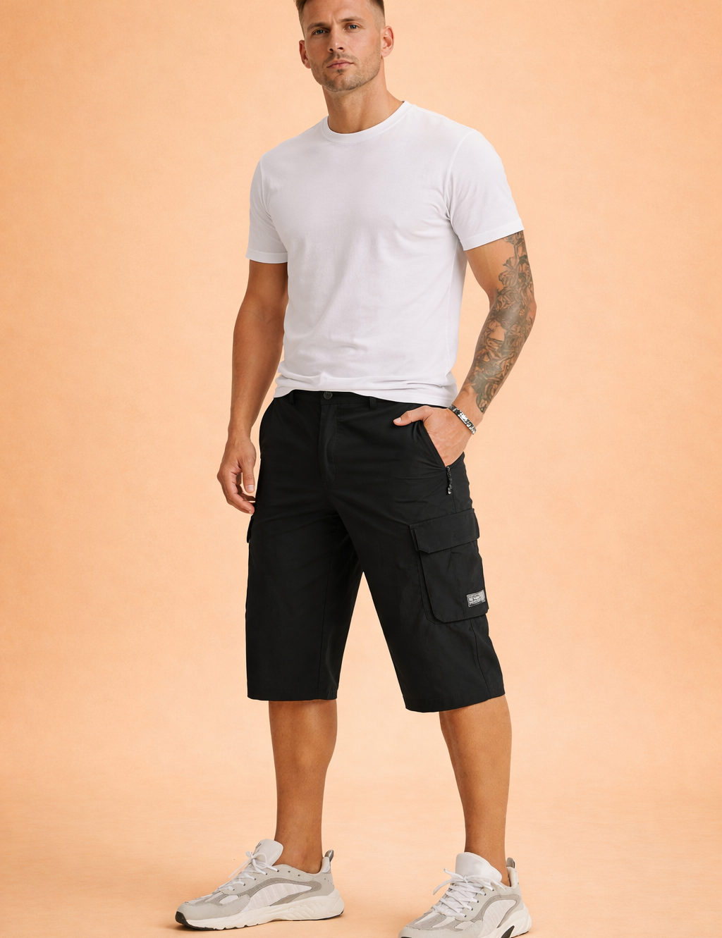 Black utility cargo shorts in smooth matte woven fabric with structured knee-length cut, reinforced seams, zippered side pocket, flap cargo pocket with stitched label, and clean solid color finish, paired with a plain olive-green short-sleeve T-shirt in soft cotton jersey with a minimal, unprinted surface and classic crew neckline, styled with neutral athletic sneakers.