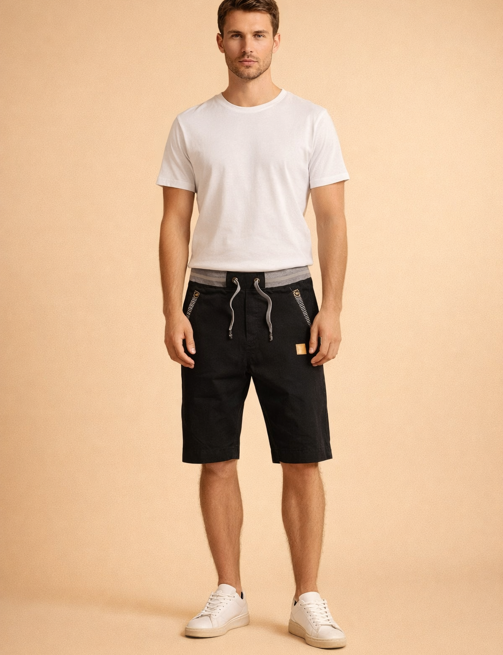 Black knee-length cotton men’s shorts with adjustable grey drawstring waistband, structured matte fabric, diagonal zip pockets with metallic detailing, subtle stitched seams, paired with a clean white short-sleeve crew-neck T-shirt in smooth cotton and minimal white low-top sneakers with a matte leather finish.