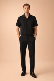 Modern black two piece mens outfit featuring a short sleeve tailored polo shirt with clean collar lines paired with slim fit tapered trousers in matching matte fabric for a refined minimalist look