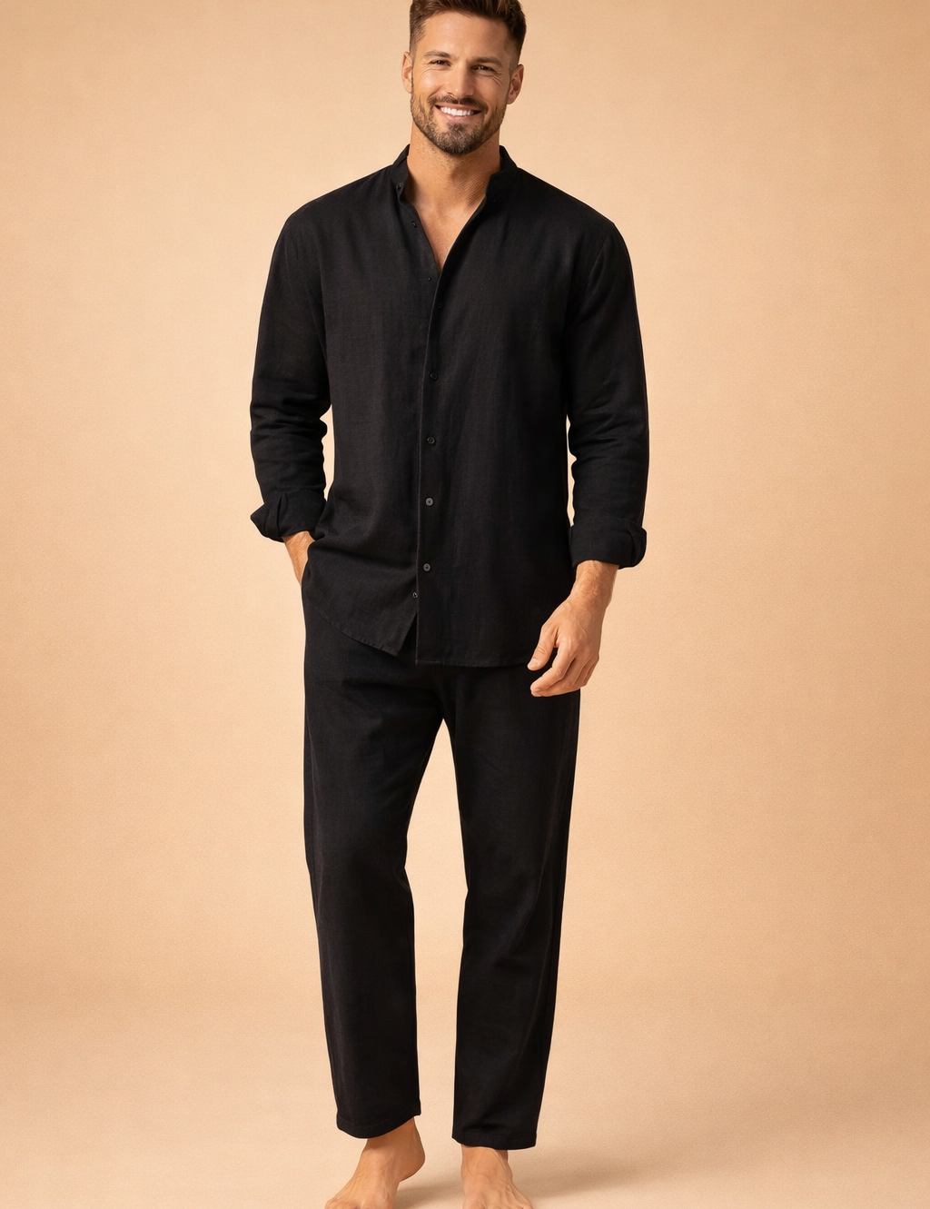 Relaxed-fit black long-sleeve button-up shirt with a soft matte texture, straight hem, and clean front placket, paired with matching black cropped trousers featuring a loose silhouette and ankle-length cut.