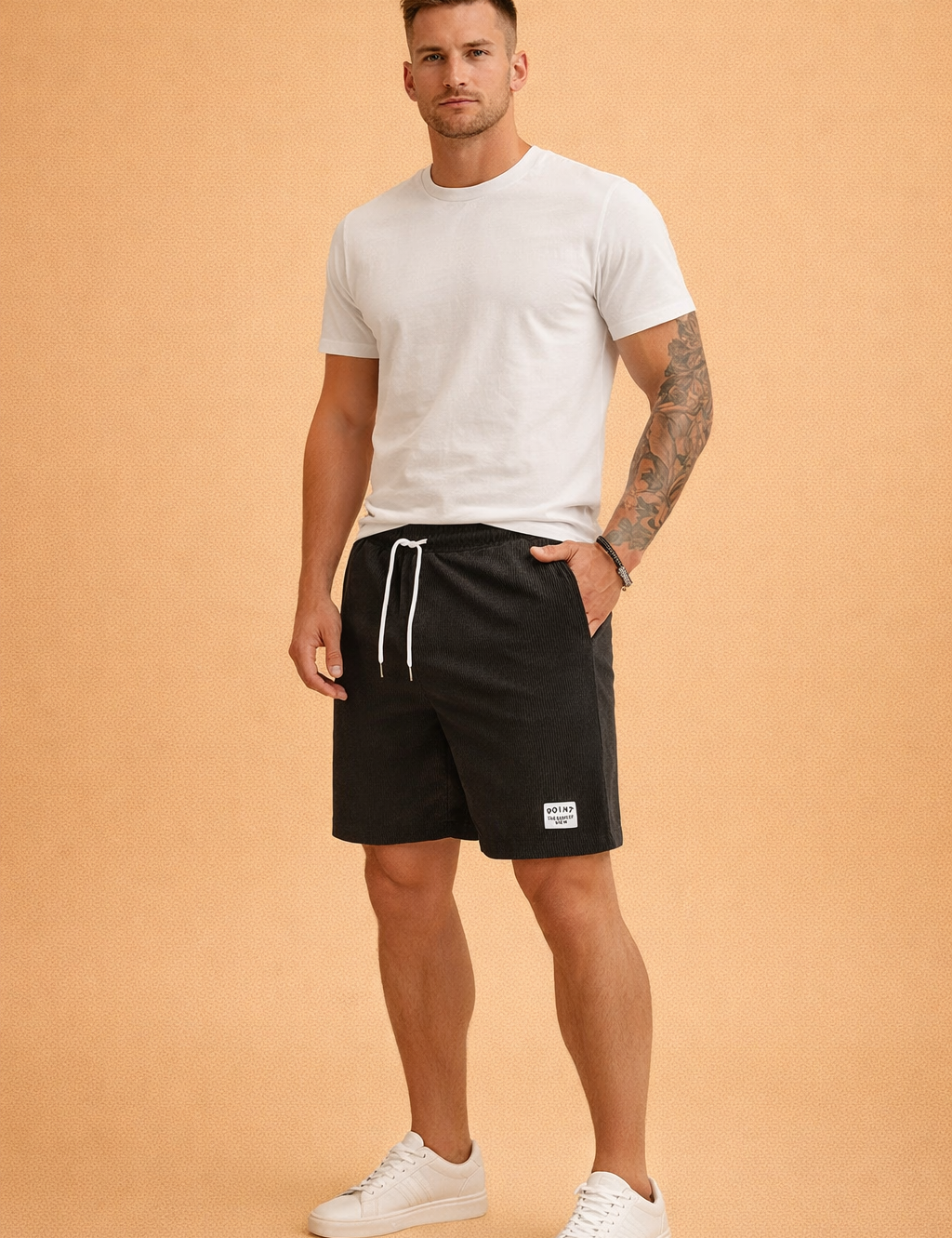 Black ribbed casual shorts made from fine vertical-rib cotton fabric, featuring an elastic waistband with white drawstring, clean side pockets, a straight knee-length cut, and a small woven “POINT” label on the lower hem, paired with a solid sage-green short-sleeve crew-neck T-shirt in smooth jersey fabric and clean white low-top sneakers for a minimal modern casual look.
