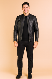 Slim-fit black leather jacket with zipper closure and stand-up collar, styled with a clean black inner layer for a sleek and modern look.