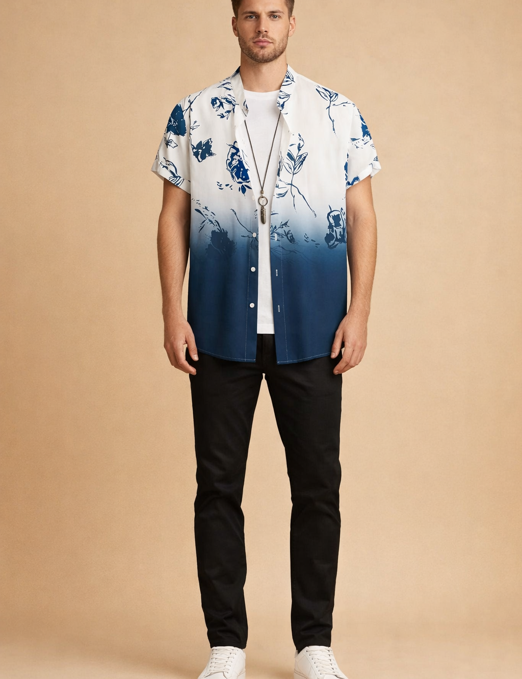 Short-sleeve button-up shirt with a white-to-deep blue gradient and abstract floral print, layered over a plain white crew-neck T-shirt, paired with slim black trousers and clean white low-top sneakers, showcasing a relaxed modern casual outfit with precise tailoring and smooth fabric drape.