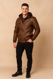 Brown leather jacket with multiple zippered chest pockets, ribbed cuffs, and a detachable burgundy hood, styled in a modern casual fit.