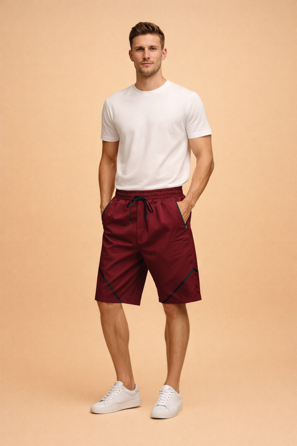 Burgundy athletic shorts with black zipper pockets and diagonal contrast accents, paired with a fitted white crew-neck T-shirt and clean white low-top sneakers for a modern sporty look