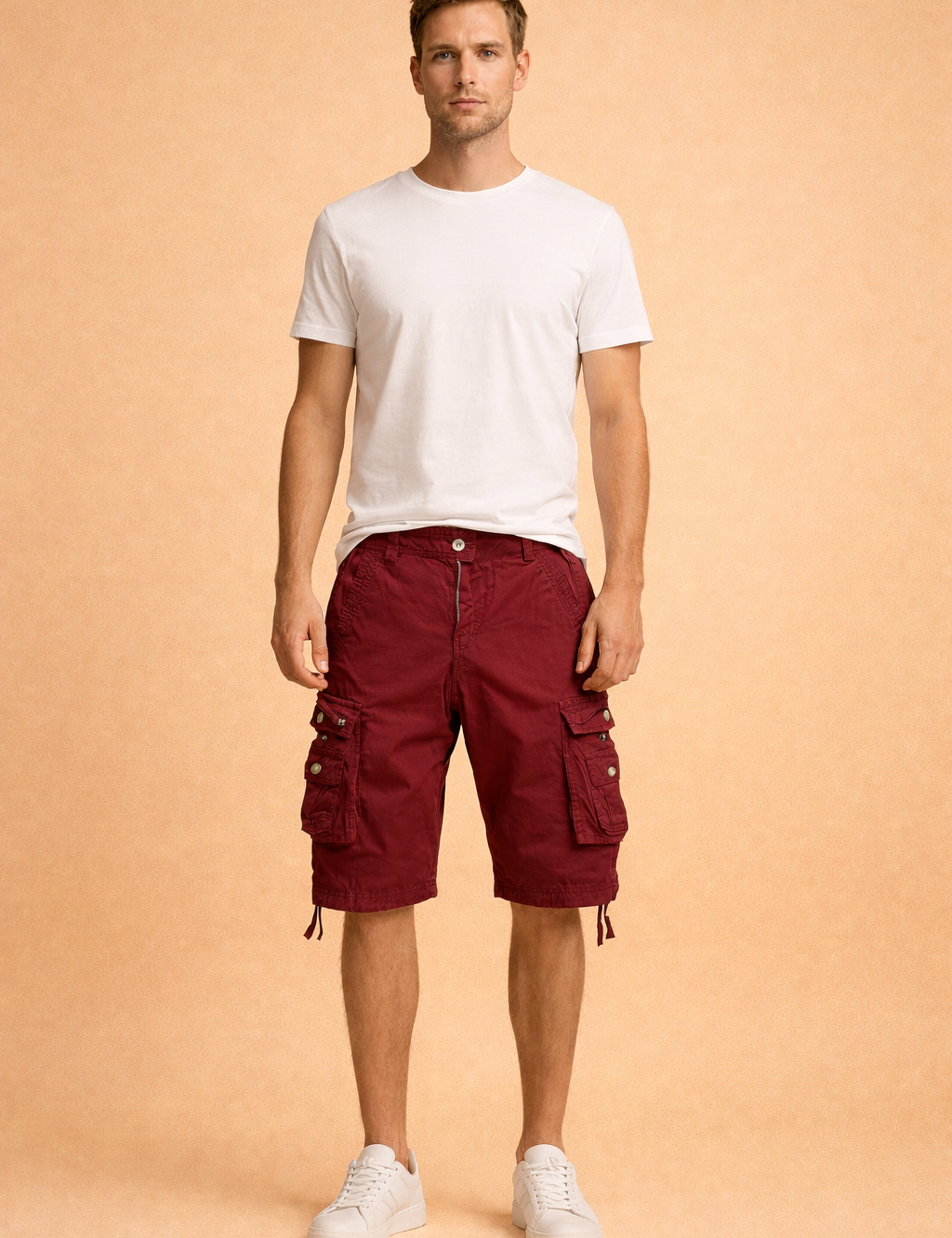Burgundy cotton cargo shorts with multi-pocket utility design, metal snap buttons, adjustable drawstring hems, paired with a plain white short-sleeve crew-neck cotton T-shirt and clean white low-top sneakers
