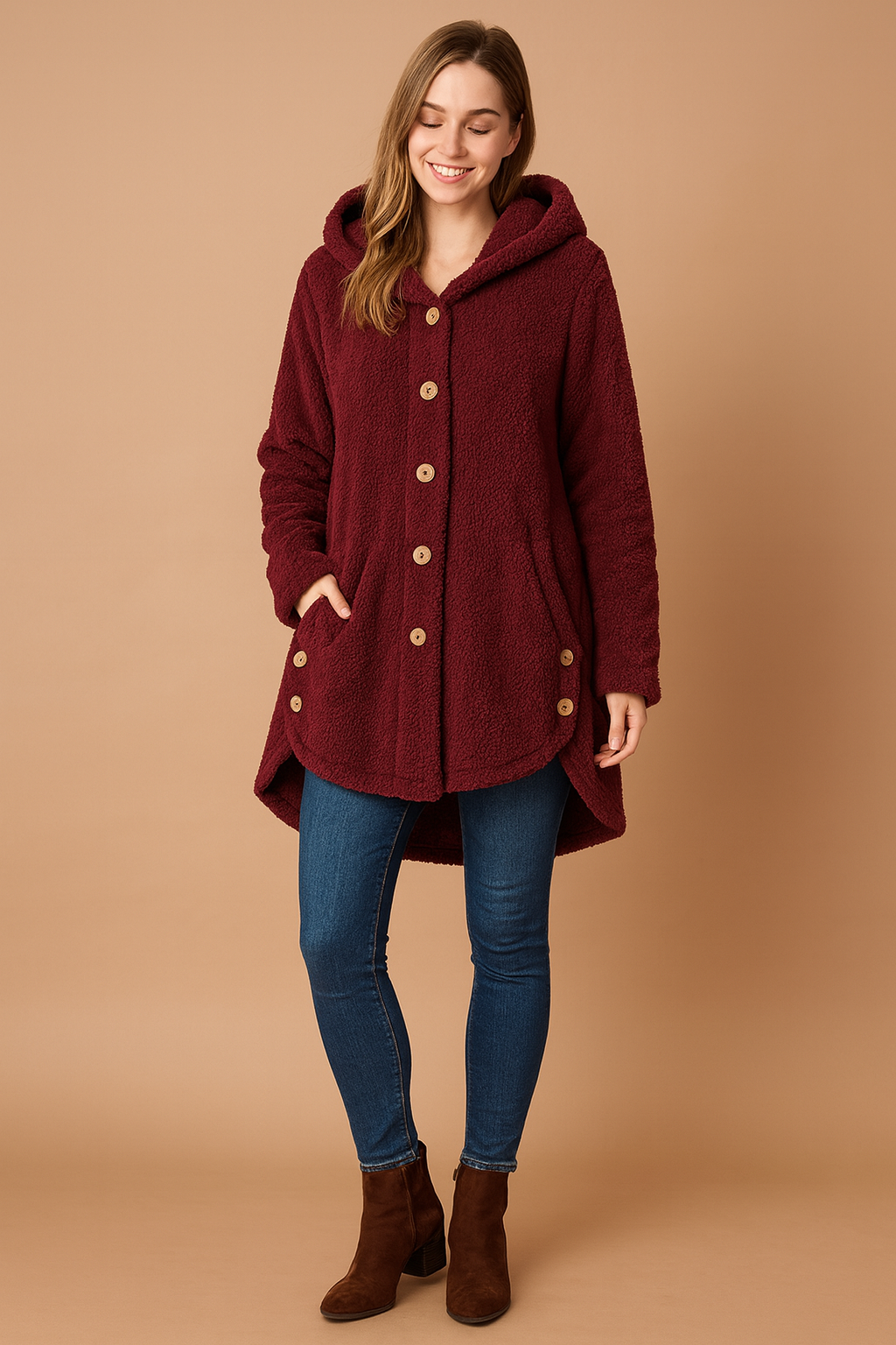 Burgundy fleece hooded button-up jacket with front pockets, designed for women. Features a mid-thigh length, long sleeves, and cozy sherpa-style fabric for warmth and comfort.