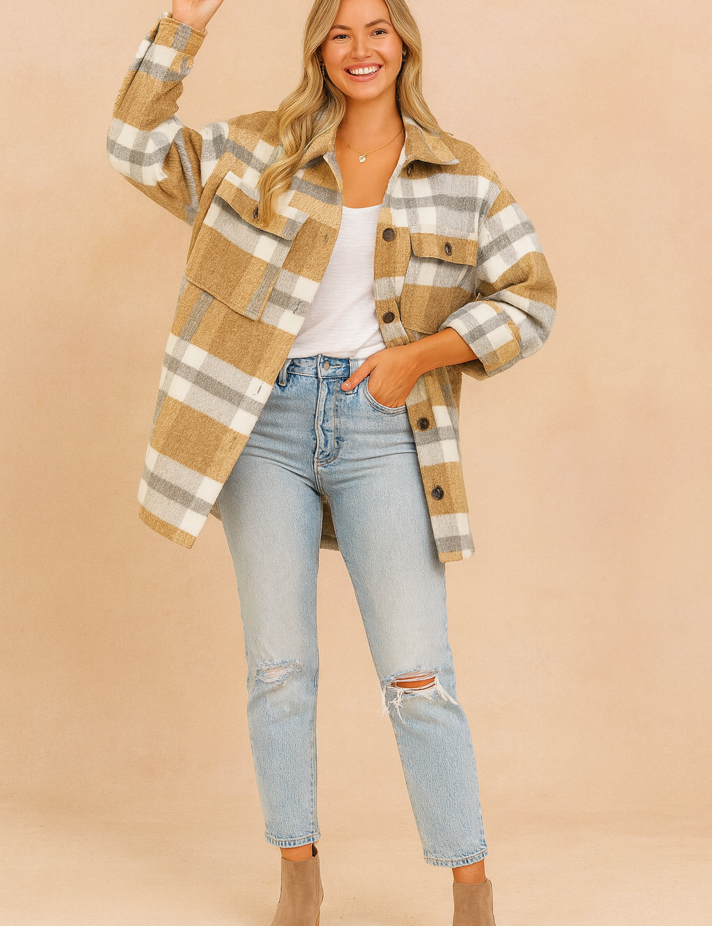 Oversized camel, white, and gray plaid jacket styled with a white T-shirt, distressed light-wash jeans, and taupe ankle boots.