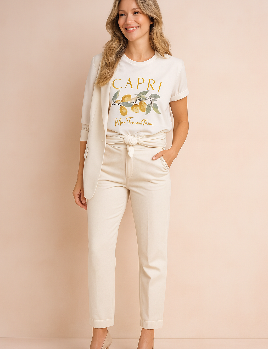 White graphic T-shirt with "Capri" and lemon branch print, paired with cream blazer and tailored trousers, styled in a casual front-knot.