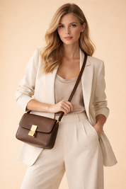 Elegant women’s cream tailored blazer paired with a satin camisole and high-waisted wide-leg trousers, styled with a brown leather crossbody handbag featuring gold hardware for a refined luxury look.