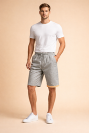Light grey drawstring summer shorts with identical smooth fabric texture and geometric hem trim, styled with a clean white crew neck short-sleeve t-shirt and minimalist white low-top sneakers for a refined casual look.