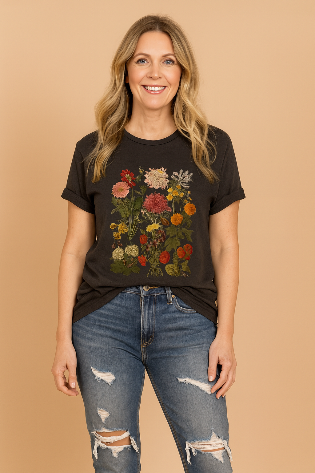 Women's charcoal graphic T-shirt with vivid multicolor botanical floral print, styled with distressed denim jeans.