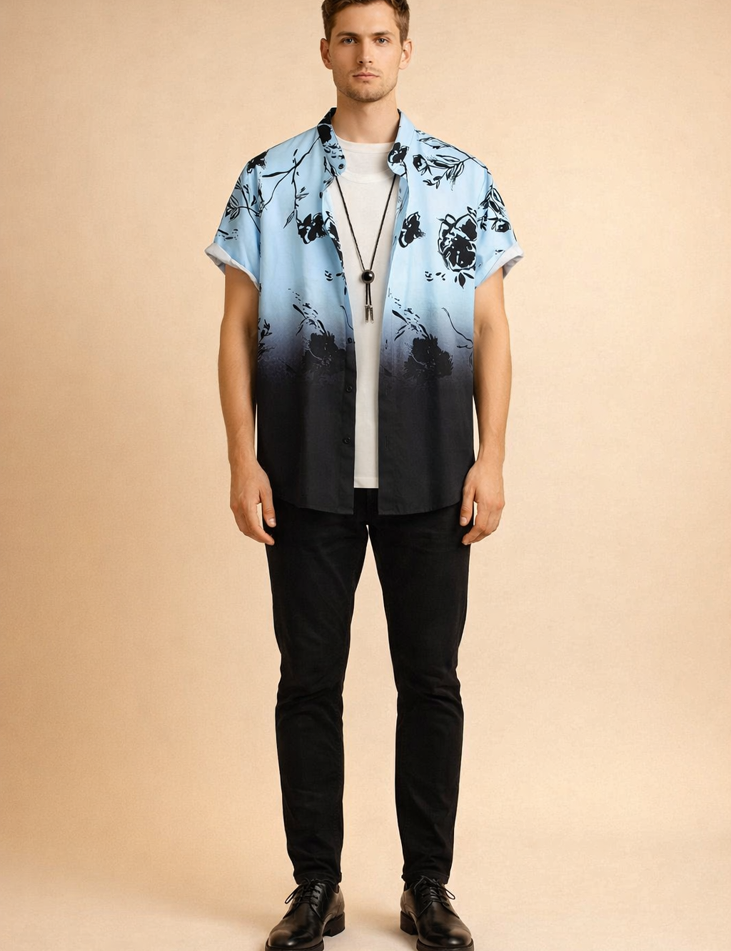 Short-sleeve button-up shirt with a light blue to deep black gradient, featuring a bold black floral print with crisp outlines and consistent color saturation, styled open over a clean white crew-neck T-shirt and finished with a minimal black cord pendant necklace.