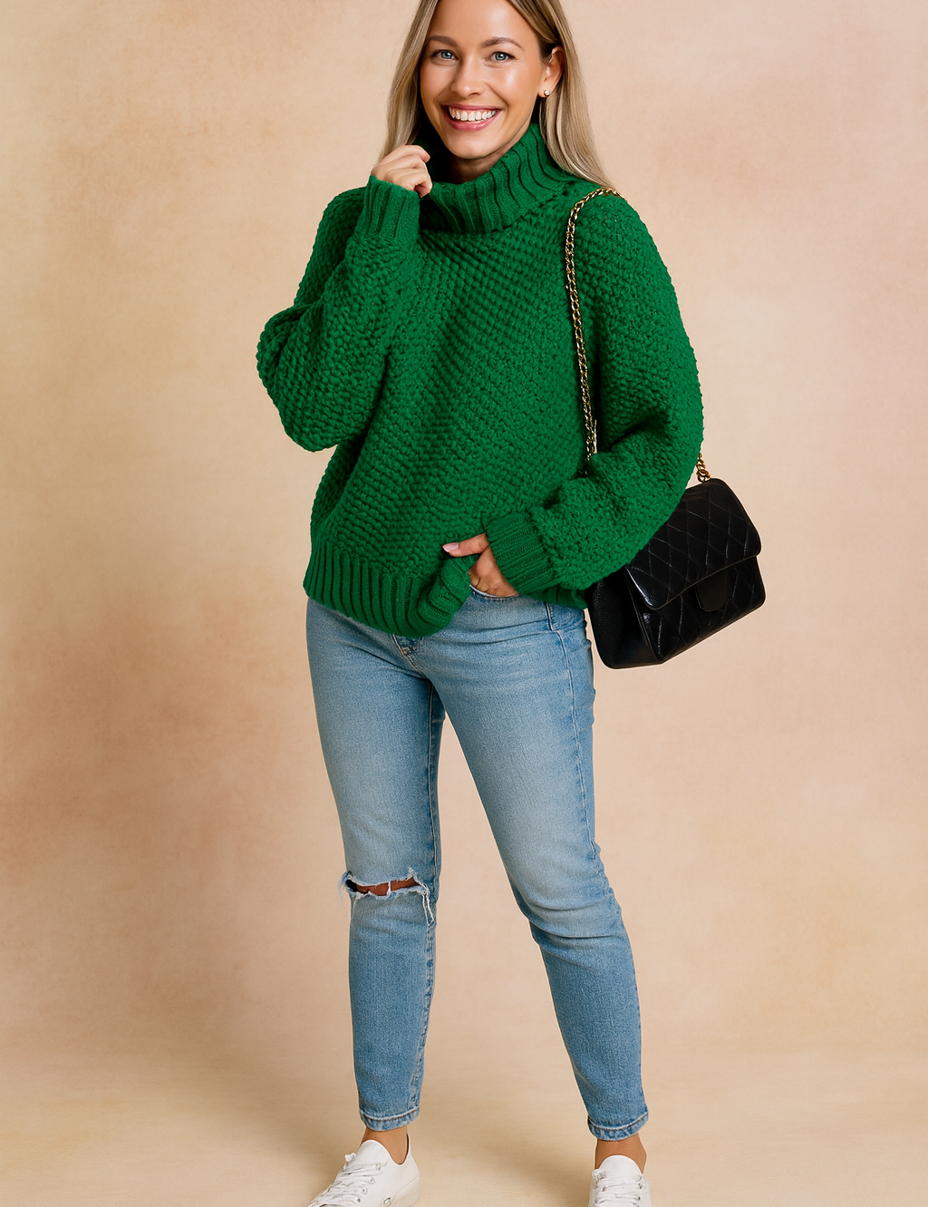 Chunky knit green turtleneck sweater with oversized sleeves, paired with light-wash ripped skinny jeans, white sneakers, and a black quilted chain-strap handbag.