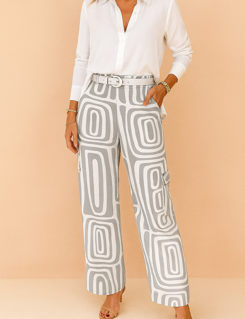 High-waisted straight-leg pants with a modern grey and white geometric print, styled with a matching belt and nude heels.
