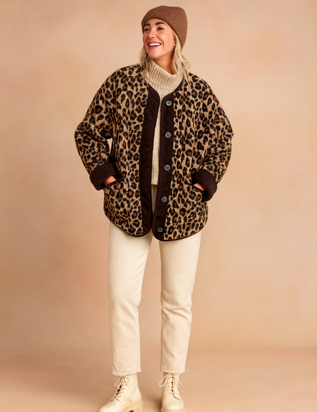 Leopard print button-up jacket with dark brown trim, paired with beige pants and cream lace-up boots.