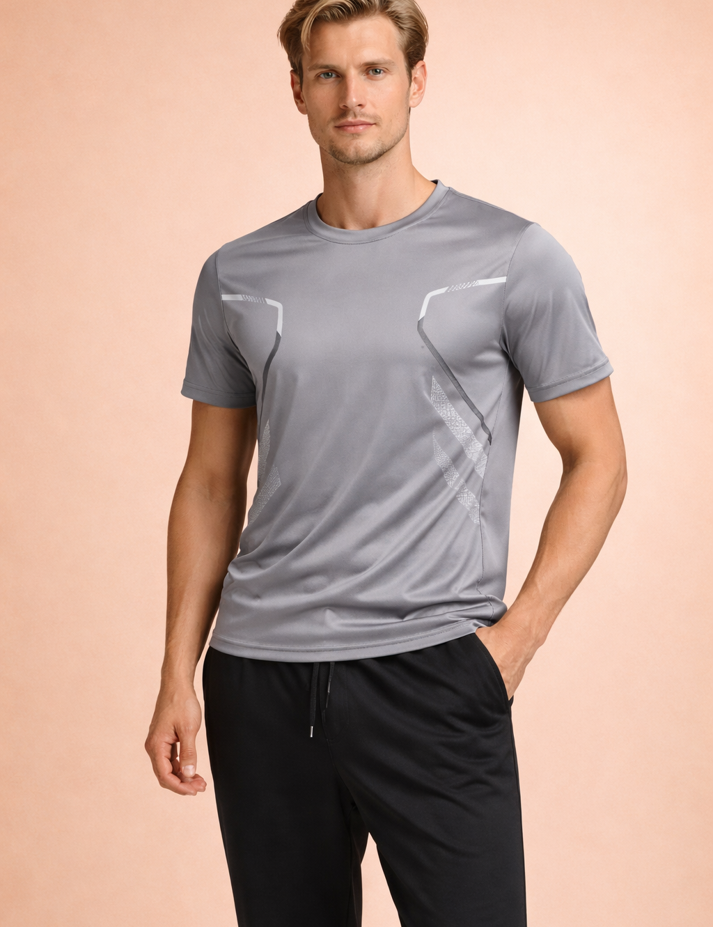 Light gray short-sleeve performance T-shirt with ergonomic panel seams, subtle geometric detailing, and a streamlined athletic fit, paired with black tapered athletic trousers for a clean, modern look.