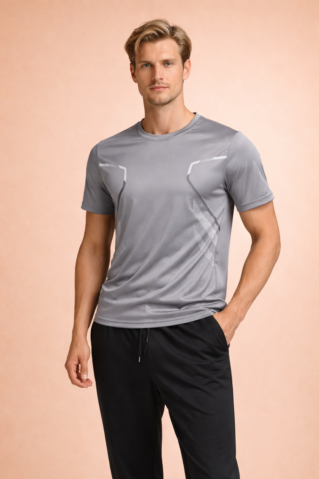 Light gray short-sleeve performance T-shirt with ergonomic panel seams, subtle geometric detailing, and a streamlined athletic fit, paired with black tapered athletic trousers for a clean, modern look.