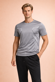 Light gray short-sleeve performance T-shirt with ergonomic panel seams, subtle geometric detailing, and a streamlined athletic fit, paired with black tapered athletic trousers for a clean, modern look.