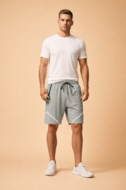 Light grey athletic shorts with elastic waistband, black drawstring closure, zippered side pocket, smooth performance fabric, and white geometric accent lines, styled with a clean white crew neck T-shirt and white minimalist sneakers for a modern sport casual look.