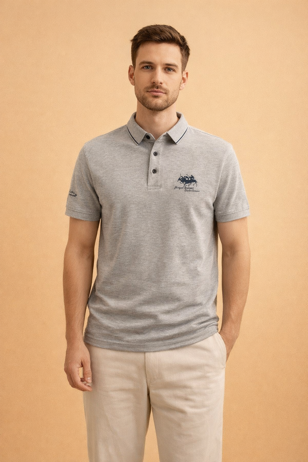 Light grey short-sleeve polo shirt with classic collar, three-button placket, and subtle embroidered chest logo, paired with straight-cut beige trousers for a clean, smart-casual look.