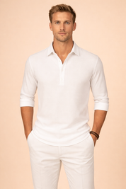 Long-sleeve polo shirt with a clean open collar, short button placket, smooth knit texture, relaxed tailored fit, and neatly rolled cuffs for a refined smart-casual silhouette.