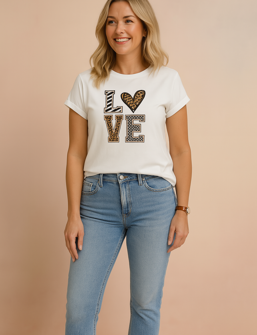 White graphic t-shirt with "LOVE" print in mixed animal and geometric patterns, styled with light-wash high-rise jeans.