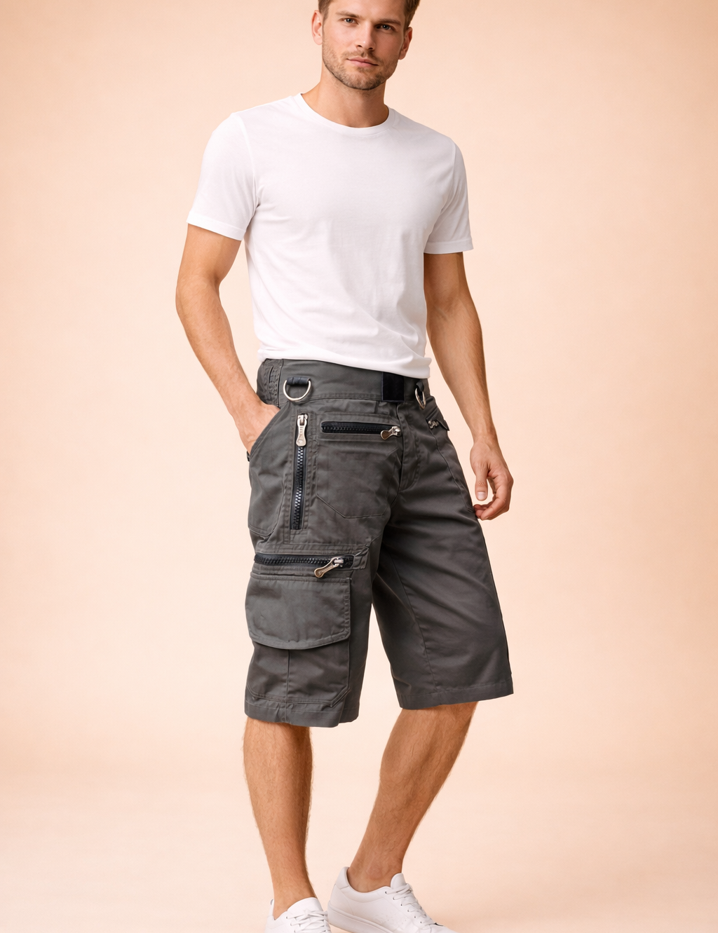 Washed charcoal gray military cargo shorts with a solid matte twill fabric, reinforced stitching, multiple utility pockets, exposed metal zippers, integrated D-ring hardware, and knee-length straight cut, styled with a solid mustard yellow short-sleeve crew-neck cotton T-shirt and clean white low-top athletic sneakers.