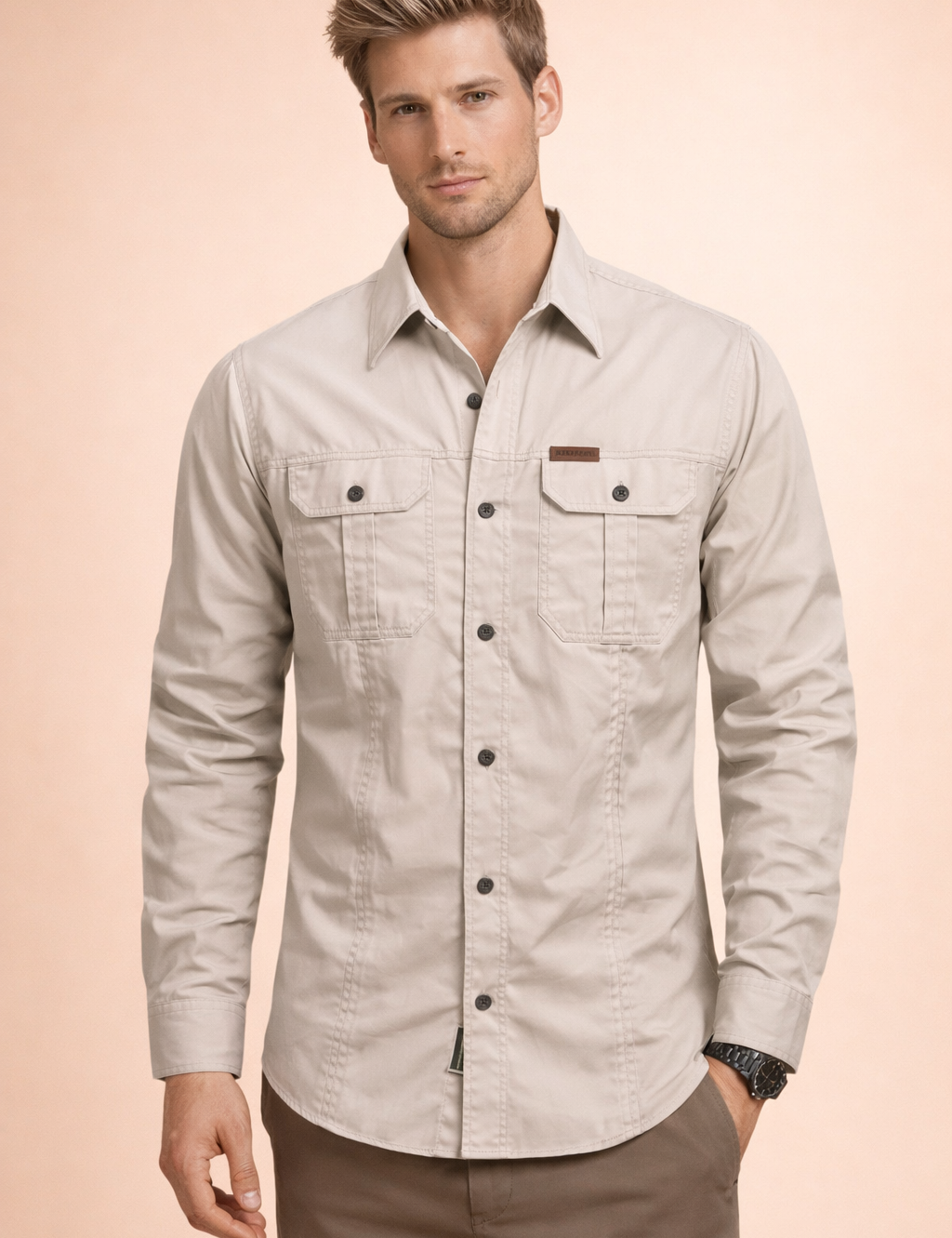 Light beige long-sleeve men’s utility button-up shirt with a structured collar, dual chest flap pockets with button closures, full front button placket, reinforced seam detailing, and a tailored straight fit.