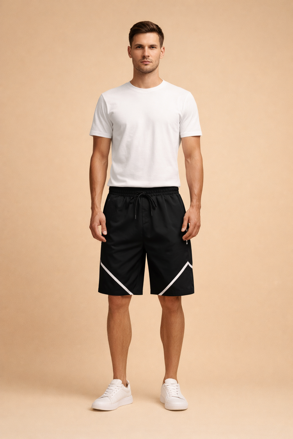Black athletic drawstring shorts with smooth matte fabric, elastic waistband, adjustable black drawcord, straight knee-length cut, and crisp diagonal white reflective stripe detailing on both legs, paired with a fitted white short-sleeve crew-neck T-shirt in soft breathable fabric and minimalist white low-profile sneakers with a clean leather finish.