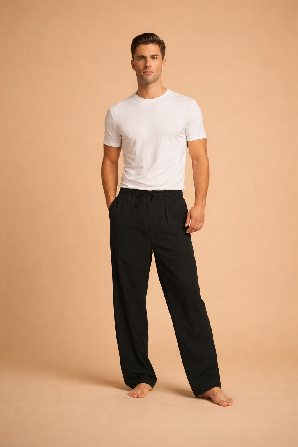 Minimalist men’s outfit featuring relaxed-fit black drawstring trousers with a straight-leg silhouette paired with a classic white short-sleeve crewneck T-shirt, styled for a clean, modern look.