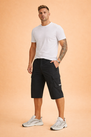 Men’s knee-length technical cargo shorts in solid matte black, featuring a lightweight smooth polyester fabric with a uniform weave, straight relaxed cut, flat front with button closure, belt loops, deep side pockets, a zippered utility pocket, and a structured flap cargo pocket on the thigh, finished with clean stitching and a minimal tactical aesthetic.