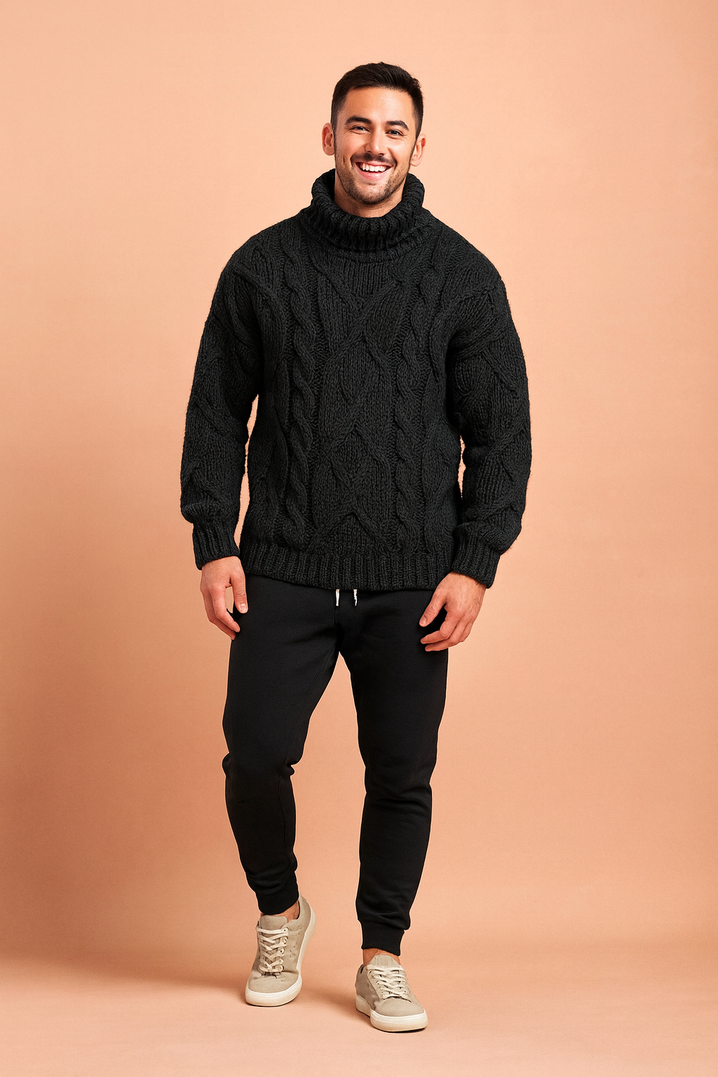 Men's chunky cable-knit turtleneck sweater in black, designed for warmth and modern style with a textured woven pattern, paired with tapered black joggers and casual grey sneakers.