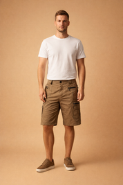Men’s knee-length cargo shorts with multiple zippered utility pockets, tailored fit, structured waistband, reinforced stitching, paired with a fitted neutral short-sleeve shirt and minimalist low-profile shoes, showcasing a functional modern menswear outfit with precise fabric texture and construction details.