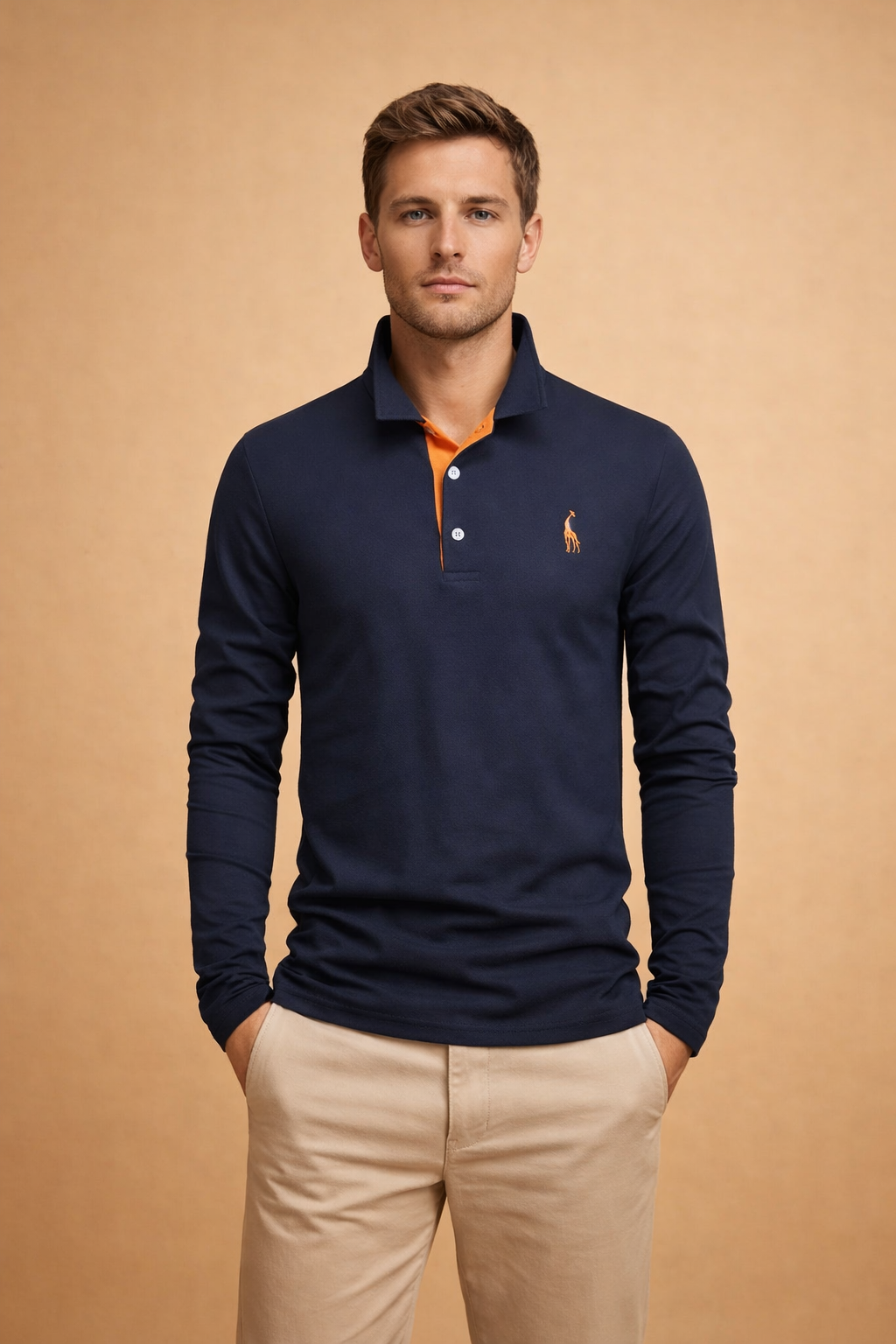Modern long-sleeve men’s polo top with a clean tailored fit, classic collar, contrast inner placket detail, buttoned neckline, subtle embroidered chest accent, paired with slim-cut neutral trousers for a refined casual look