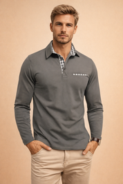 Long-sleeve tailored polo top with structured collar, clean button placket, subtle contrast check detail at the neckline and chest pocket trim, slim modern fit, styled with classic straight-leg trousers.