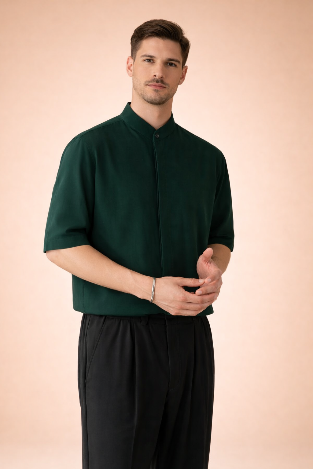 Men’s short-sleeve tailored shirt with a clean mandarin collar, concealed button placket with a single visible top button, smooth structured fabric with a fluid drape, paired with straight-leg trousers featuring a relaxed fit, soft pleating, and a clean waistband finish.