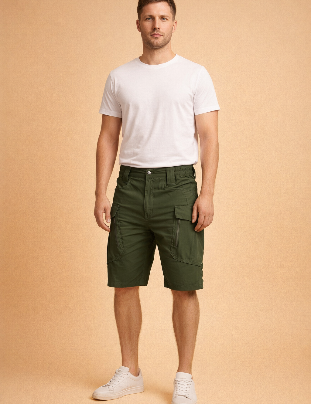 Military green cotton cargo shorts with reinforced stitching, utility flap pockets, structured waistband, and a straight tactical cut, paired with a clean white short-sleeve crew-neck T-shirt and minimalist white low-top sneakers for a modern utility-casual look.