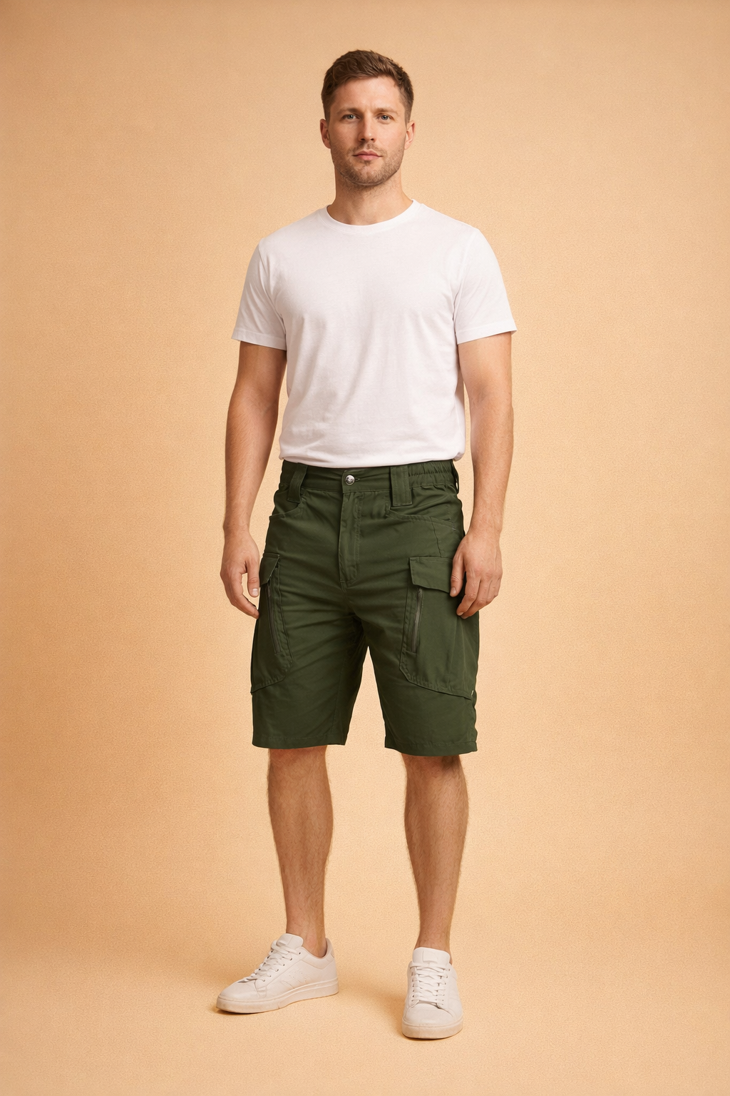 Military green cotton cargo shorts with reinforced stitching, utility flap pockets, structured waistband, and a straight tactical cut, paired with a clean white short-sleeve crew-neck T-shirt and minimalist white low-top sneakers for a modern utility-casual look.