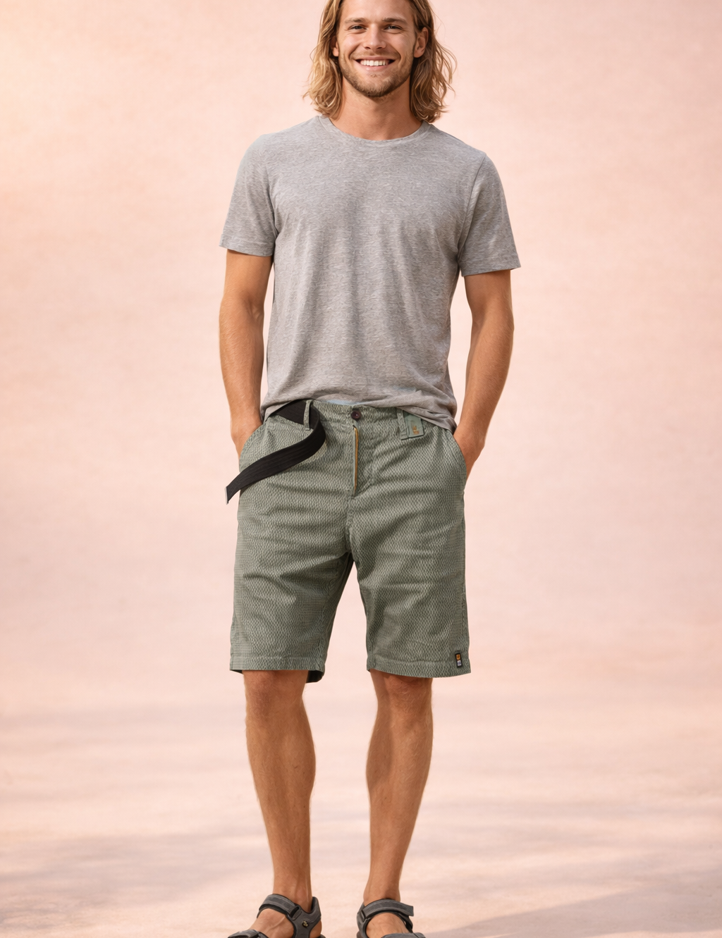 Men’s lightweight outdoor shorts in muted olive-khaki with a fine micro-check woven texture, breathable fabric construction, mid-thigh straight cut, zip fly with single button closure, integrated black webbing belt, clean hem finish, and durable casual utility styling.