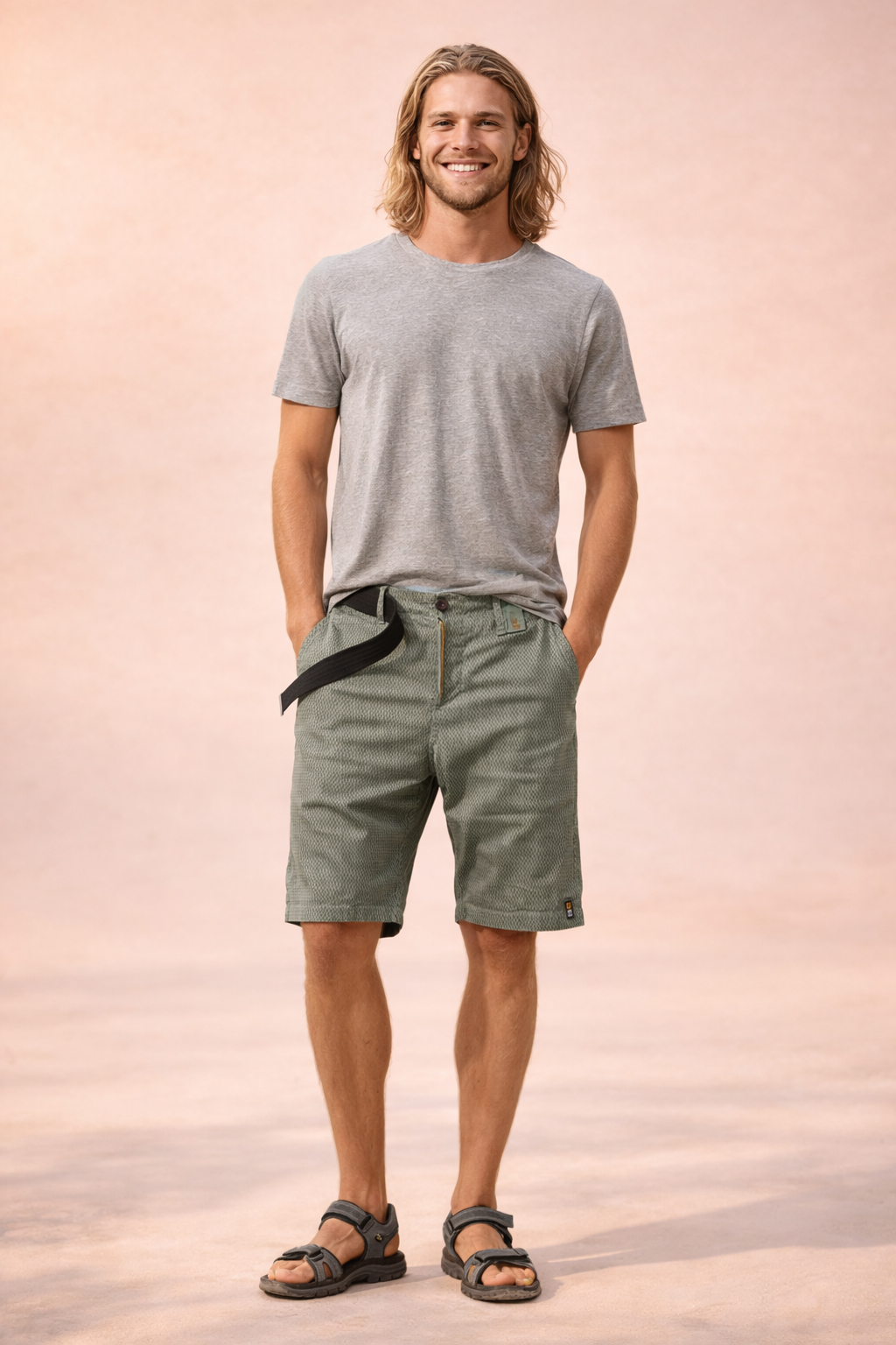 Men’s lightweight outdoor shorts in muted olive-khaki with a fine micro-check woven texture, breathable fabric construction, mid-thigh straight cut, zip fly with single button closure, integrated black webbing belt, clean hem finish, and durable casual utility styling.