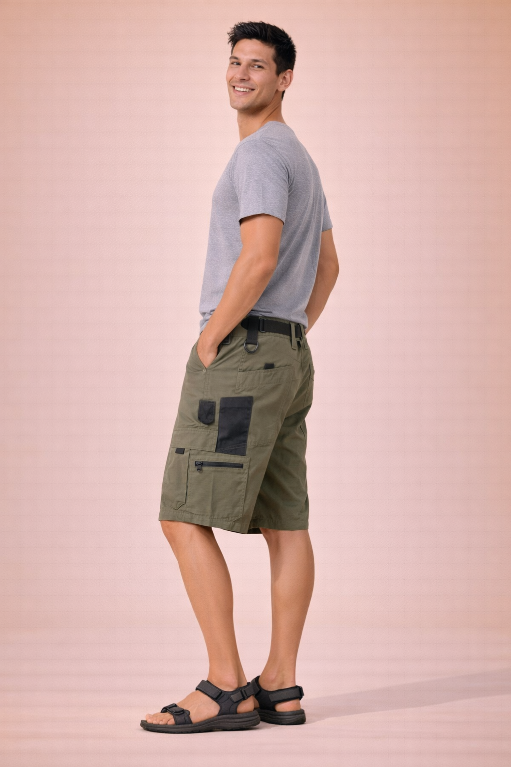 Men’s tactical cargo shorts in solid olive green with visible ripstop grid fabric texture, straight above-knee length, zip fly with single button closure, reinforced belt loops, multi-pocket utility design with side cargo flap pockets and zip pocket detail, clean stitched hems, and durable outdoor construction.