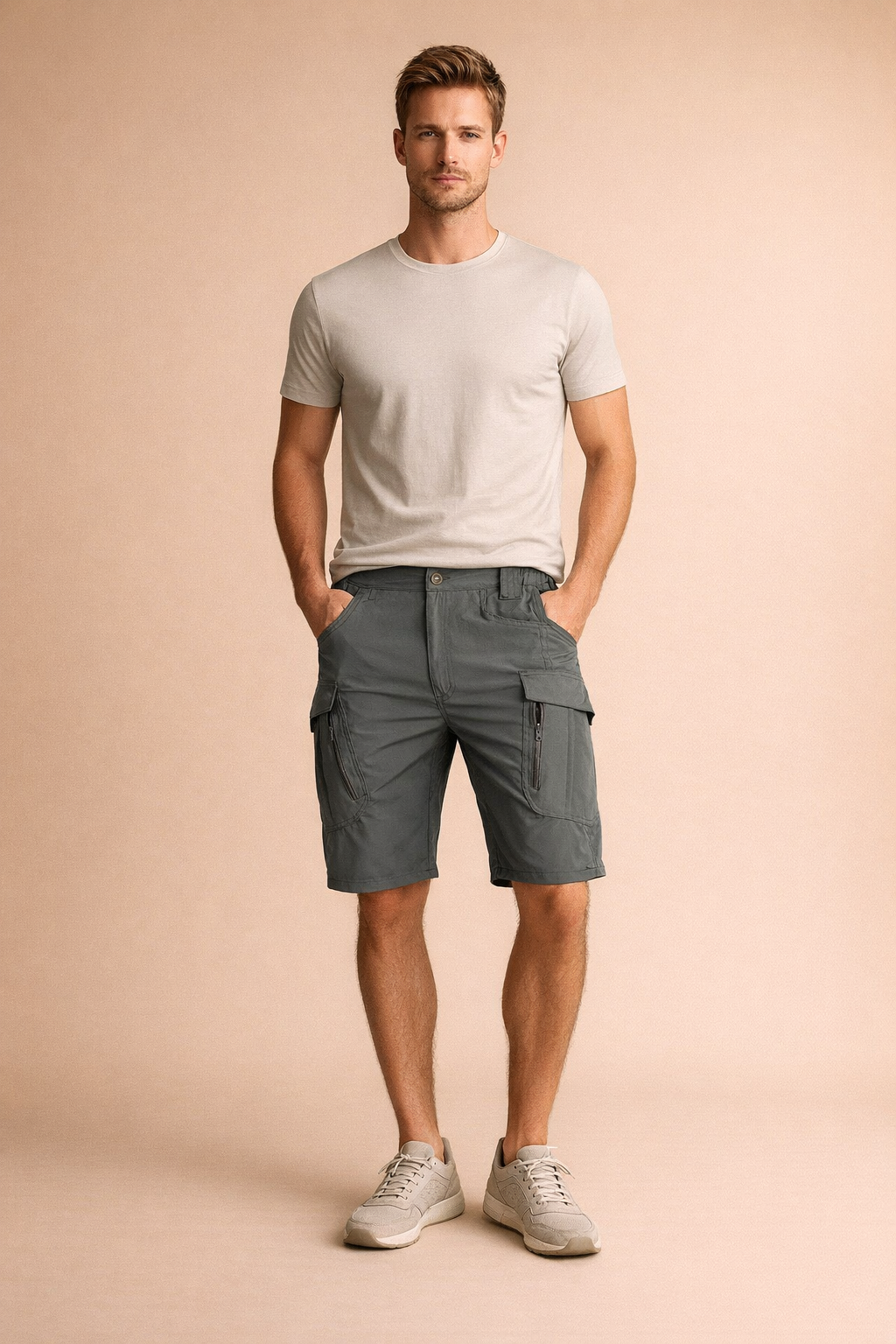 Mens tactical cargo shorts in muted slate green featuring durable woven fabric, straight knee length cut, reinforced stitching, elasticated waistband sections, front button closure, multiple utility pockets with zip and flap details, and structured seams designed for functional everyday wear.