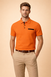 Men’s short-sleeve polo top with a structured textured surface, classic collar, two-button placket, and contrasting chest detail, styled with tailored straight-leg chinos for a clean modern look.