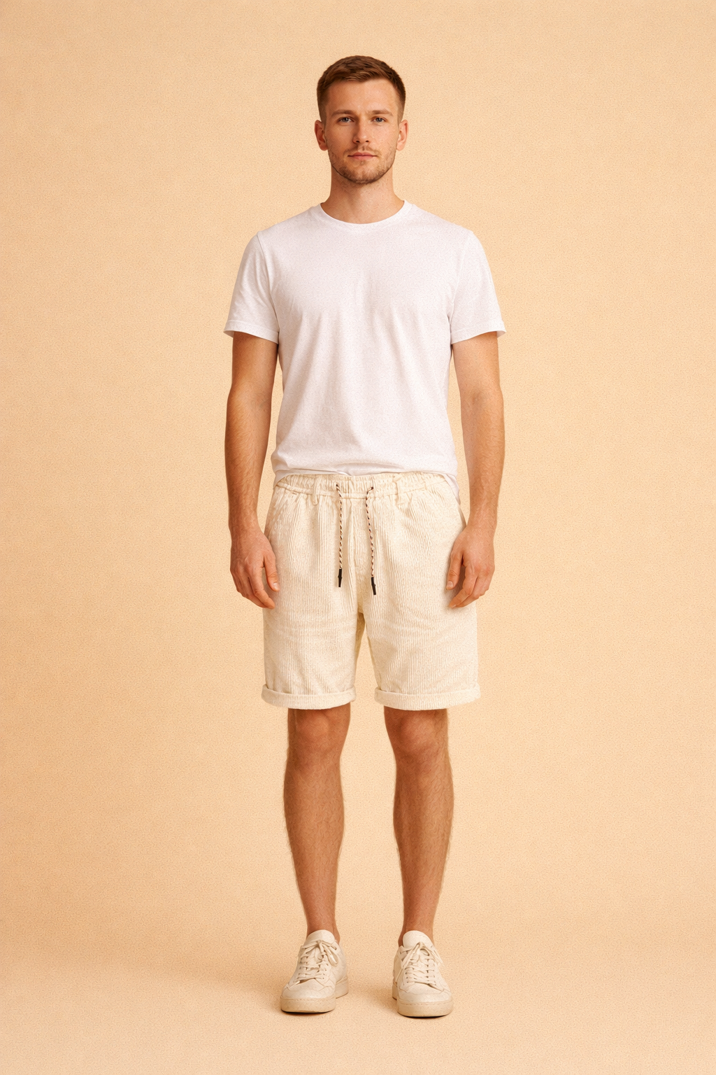 Men’s summer outfit featuring ribbed cord-style drawstring shorts with a subtle vertical texture, styled with a clean minimalist short-sleeve shirt and low-profile casual shoes for a refined warm-weather look.