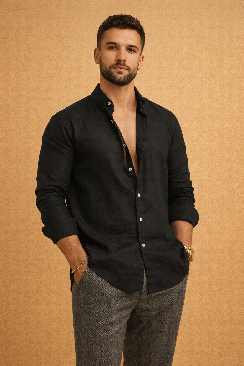 Men’s tailored long-sleeve black button-front top with a clean structured collar, smooth refined finish, relaxed fit, and paired with slim straight-leg trousers for a modern polished look.