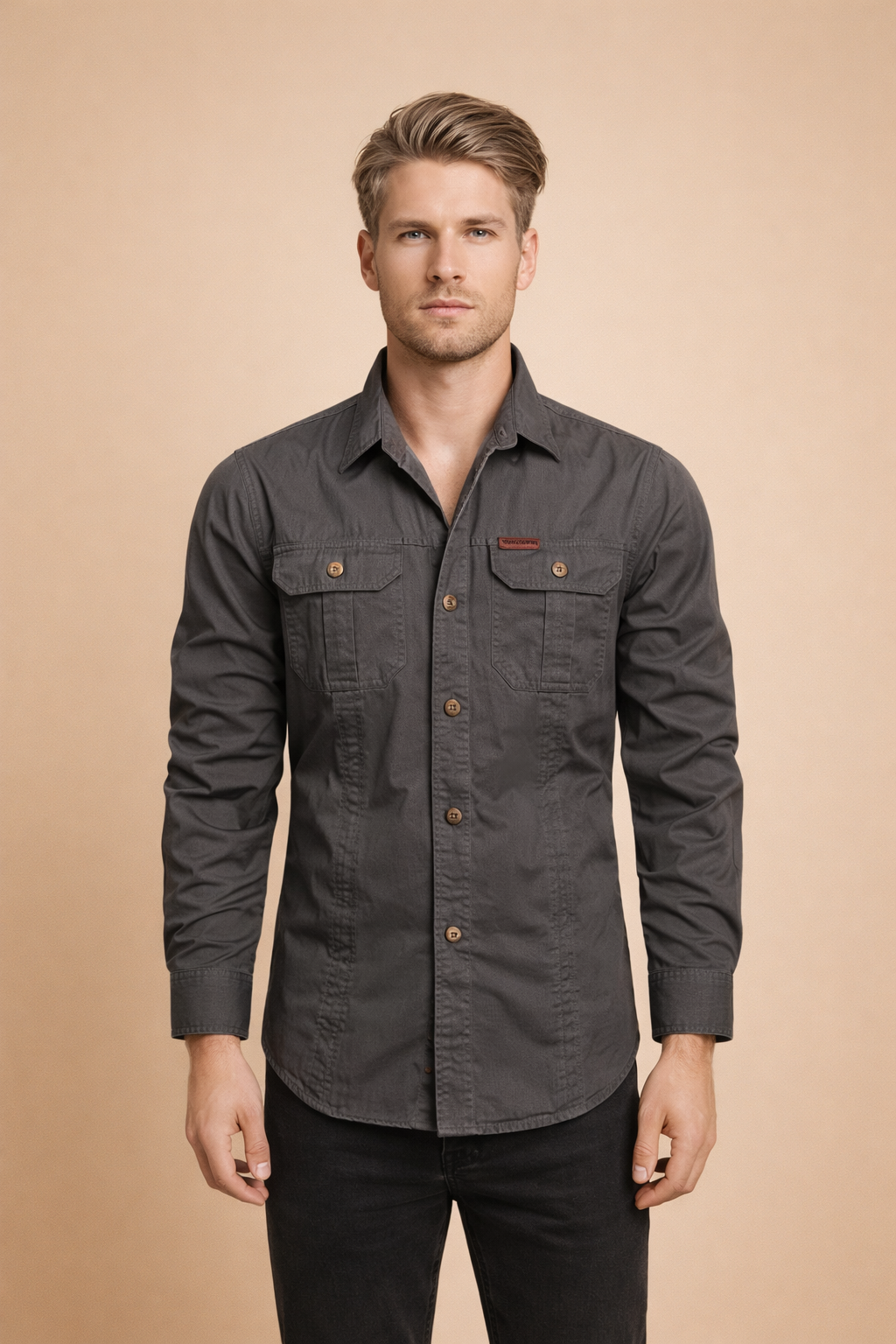 Long-sleeve button-down utility shirt with structured collar, dual chest flap pockets with button closures, straight hemline, reinforced seams, and matte woven fabric designed for a clean, tailored fit.