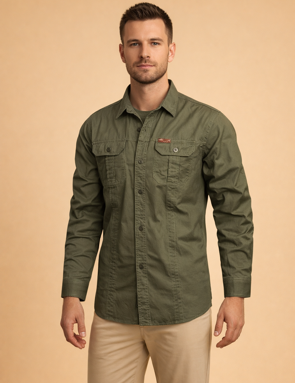 Men’s long-sleeve utility button-up shirt with structured collar, front button closure, dual chest flap pockets, and reinforced seam detailing, styled with straight-cut tailored trousers for a clean modern look.